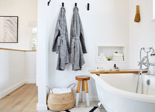 clean white bathroom with wooden floors and accents