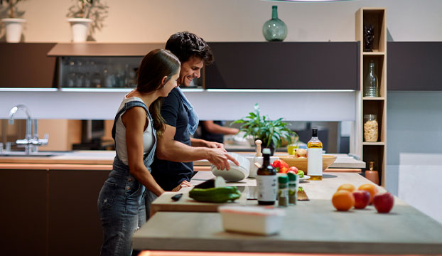 couple cooking together in home kitchen